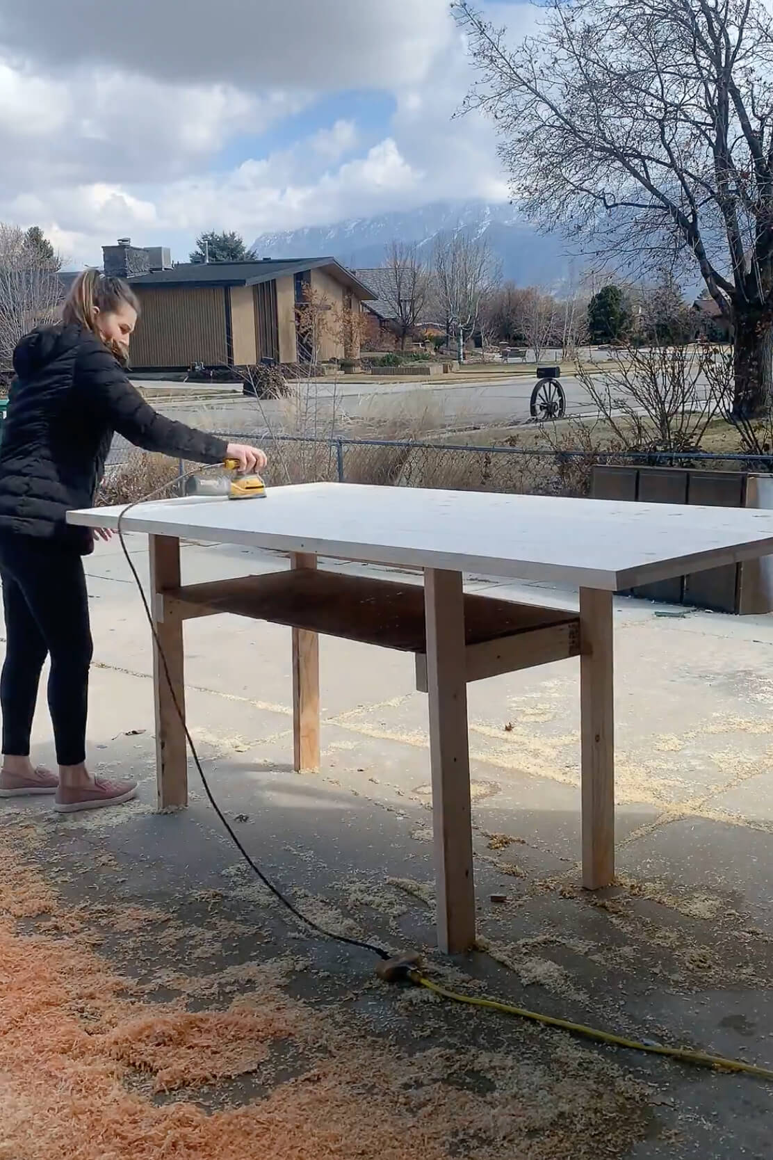 Sanding while building a DIY table.